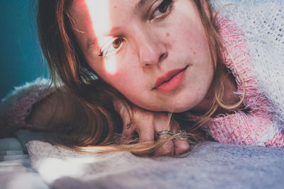 Portrait of young woman lying down