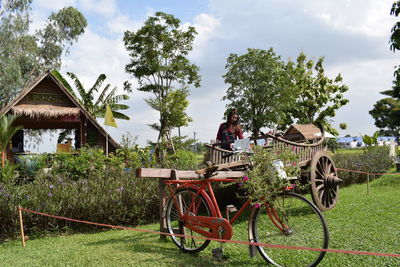 Traditional windmill on field against sky