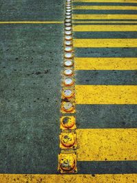High angle view of yellow sign on road