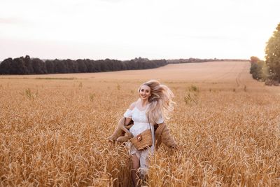 Rear view of woman standing on field