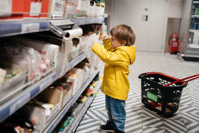 Portrait of young woman standing in store