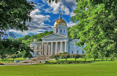 Built structure against sky with lawn in foreground