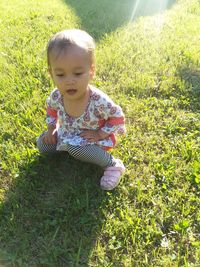 Cute baby girl on field