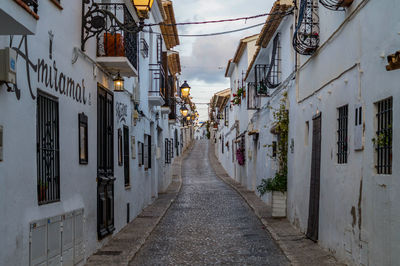 Empty alley amidst buildings in city