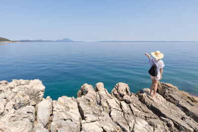 Man looking at sea against sky