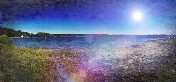 Scenic view of lake against blue sky