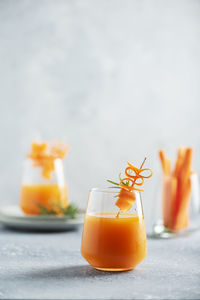 Close-up of orange juice in glass on table