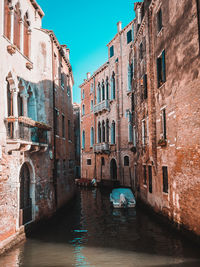Canal amidst buildings in venice, italy