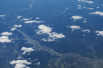 Aerial view of sea and mountain against sky