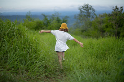 Rear view of man standing on field