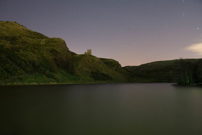 Scenic view of lake against sky at night