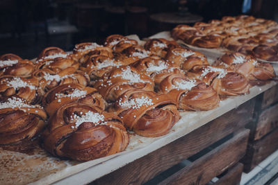 Rows of fresh danish pastries on a window display of a bakery, selective focus.