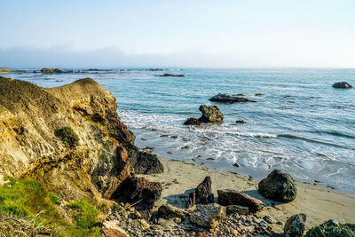 Close-up of rock formation by sea against sky