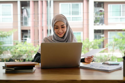 Young woman using laptop at office