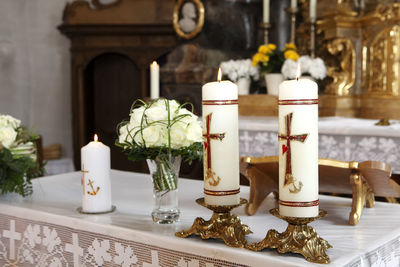 Close-up of illuminated candles on table