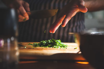 Midsection of person preparing food in kitchen