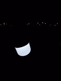 Low angle view of illuminated lighting equipment against sky at night