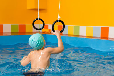 Shirtless boy in swimming pool