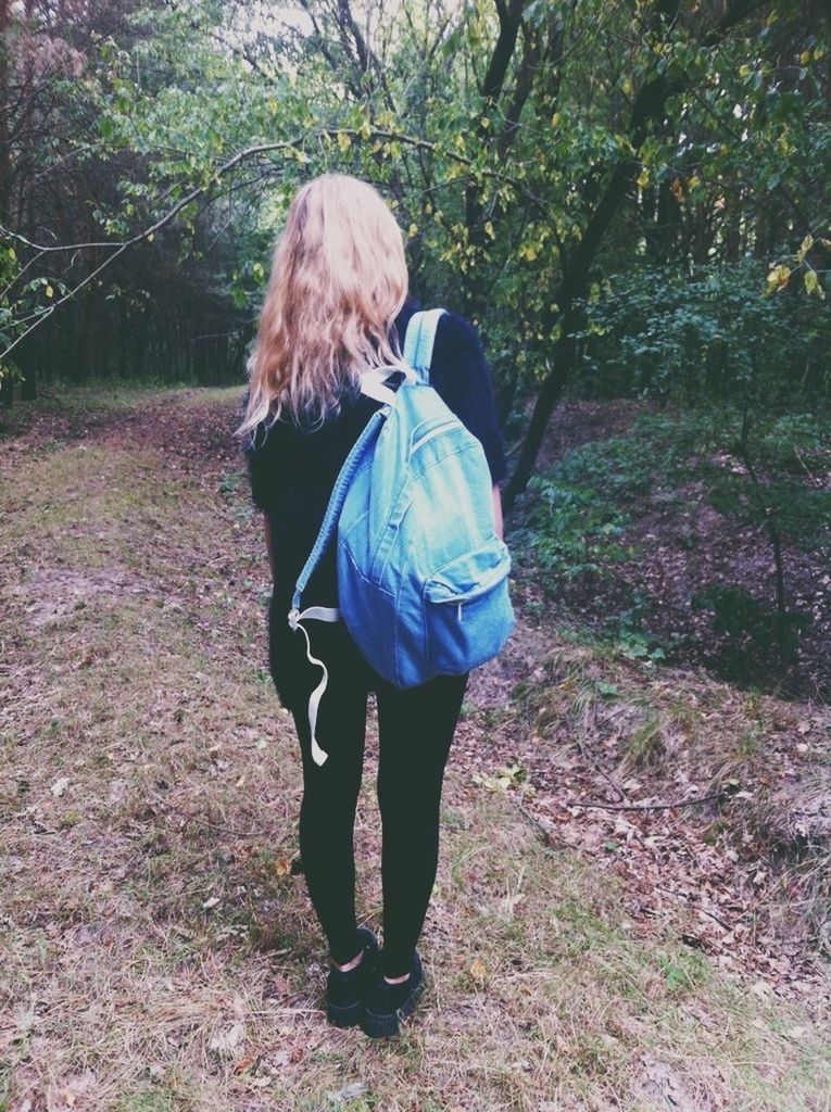 full length, rear view, casual clothing, lifestyles, leisure activity, standing, tree, forest, walking, nature, day, long hair, person, outdoors, growth, backpack, warm clothing