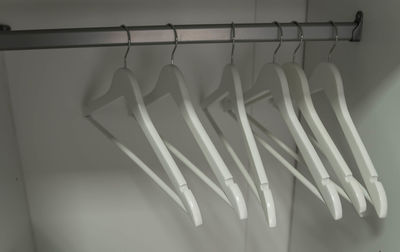 Wooden hangers. close up of white hangers. clothes on a rail