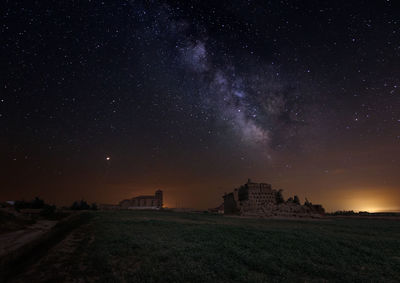 Scenic view of field against sky at night