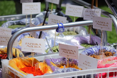 Various spices with labels in push cart