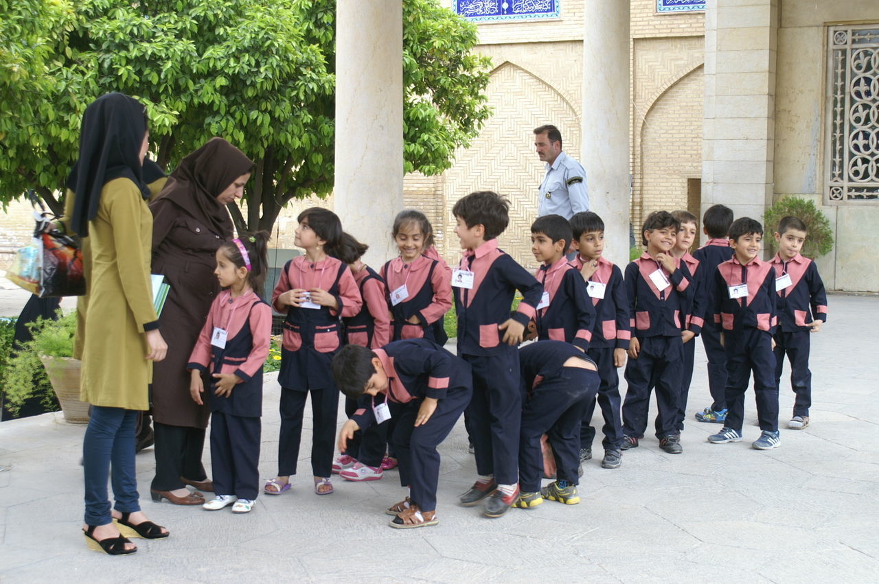 GROUP OF PEOPLE STANDING ON STREET