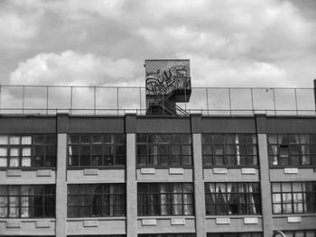 Low angle view of building against cloudy sky