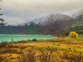 Scenic view of lake and mountains against sky