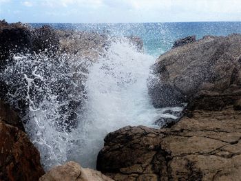 Sea waves splashing on rocks