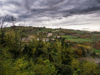 Panoramic view of trees and buildings against sky