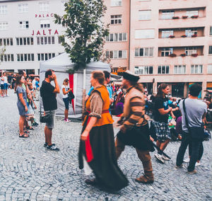 Group of people walking on street in city