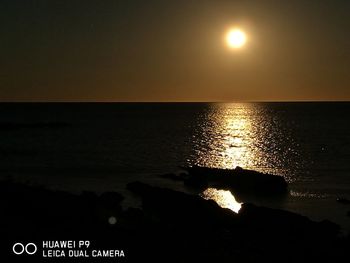 Scenic view of sea against sky at sunset