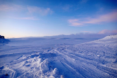 Scenic view of snow covered mountains against sky