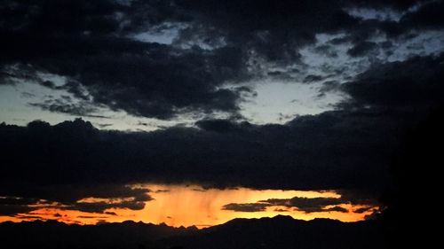 Dramatic sky over silhouette mountains