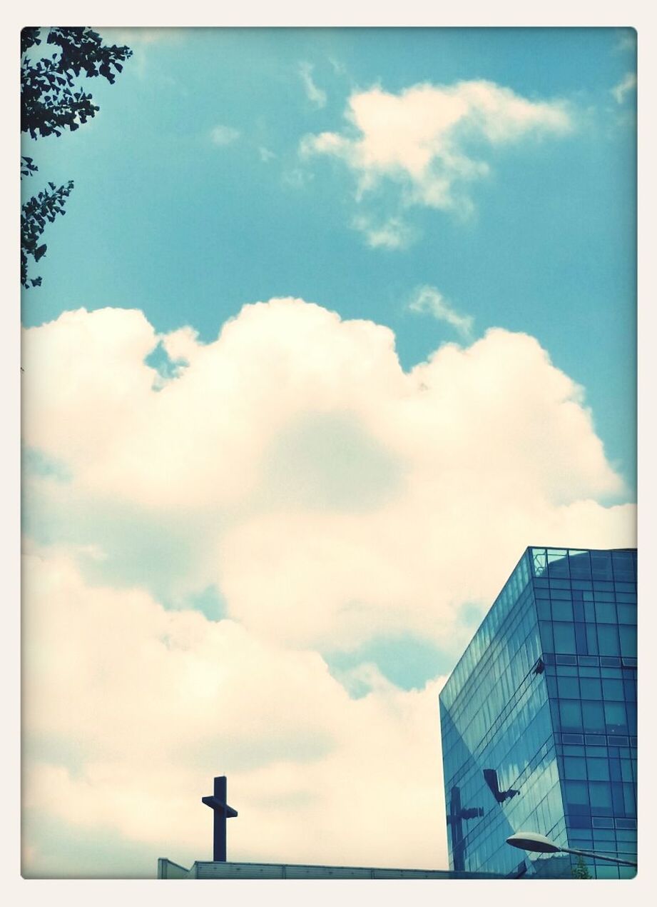 transfer print, sky, cloud - sky, low angle view, auto post production filter, building exterior, cloud, cloudy, blue, built structure, architecture, day, outdoors, no people, nature, high section, weather, sunlight, cloudscape, building