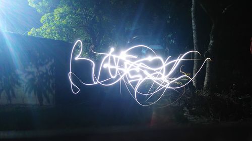 Close-up of illuminated light against sky at night