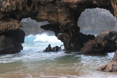 Scenic view of sea and rocks against sky