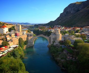 High angle view of bridge over river against blue sky