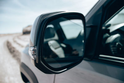 Reflection of car on side-view mirror