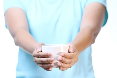 Midsection of man holding coffee cup