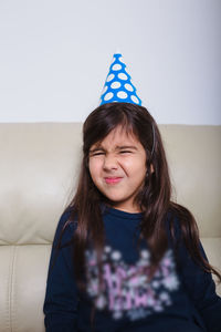 Portrait of smiling girl on sofa at home