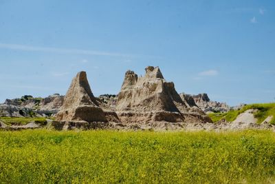 Scenic view of rocks on field against sky