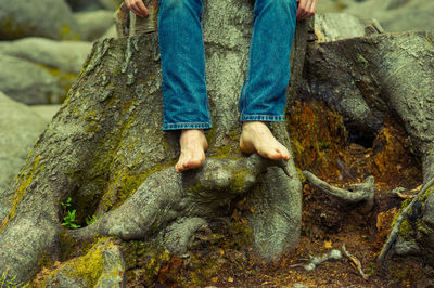 Low section of man standing on rock