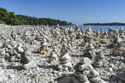 Rovinj beach covered with stacked stones creating one of the most interesting beaches in istria