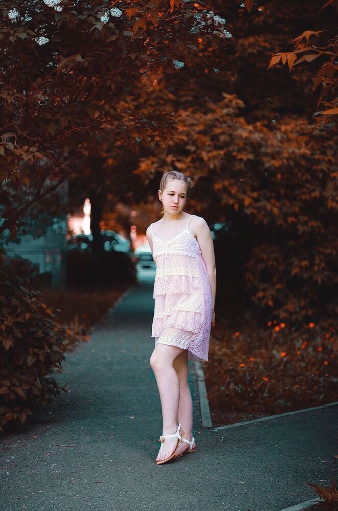 lifestyles, casual clothing, full length, person, street, standing, leisure activity, looking at camera, portrait, autumn, front view, tree, road, outdoors, footpath, sidewalk, childhood, day