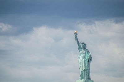 Low angle view of statue against cloudy sky