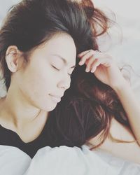 Close-up of woman sleeping on bed