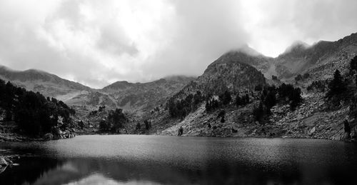 Scenic view of lake and mountains against sky