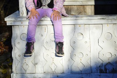 Low section of girl sitting on floor